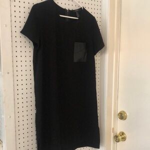 Black pullover dress with zipper. Leather pocket.